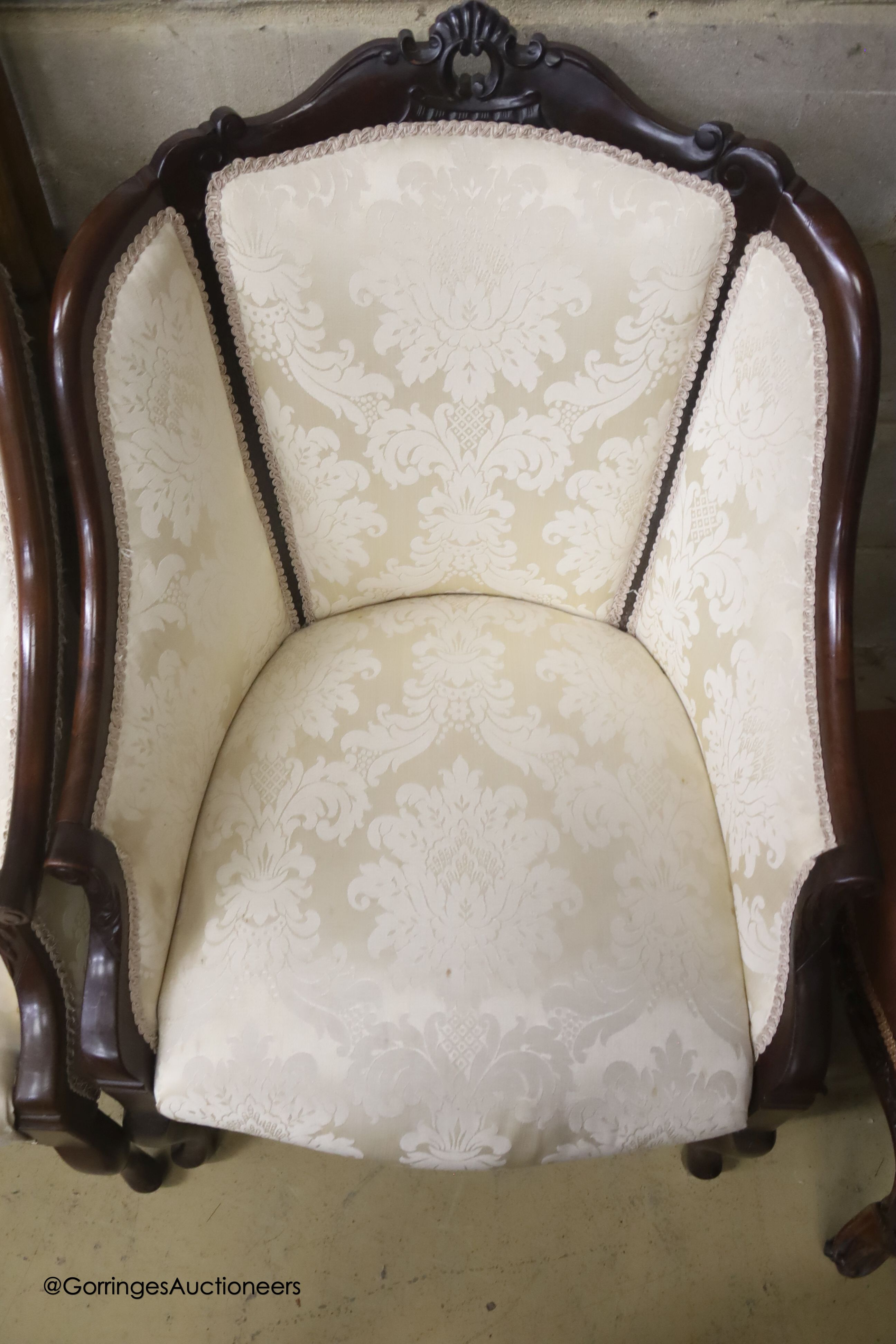 A late Victorian mahogany three piece salon suite
